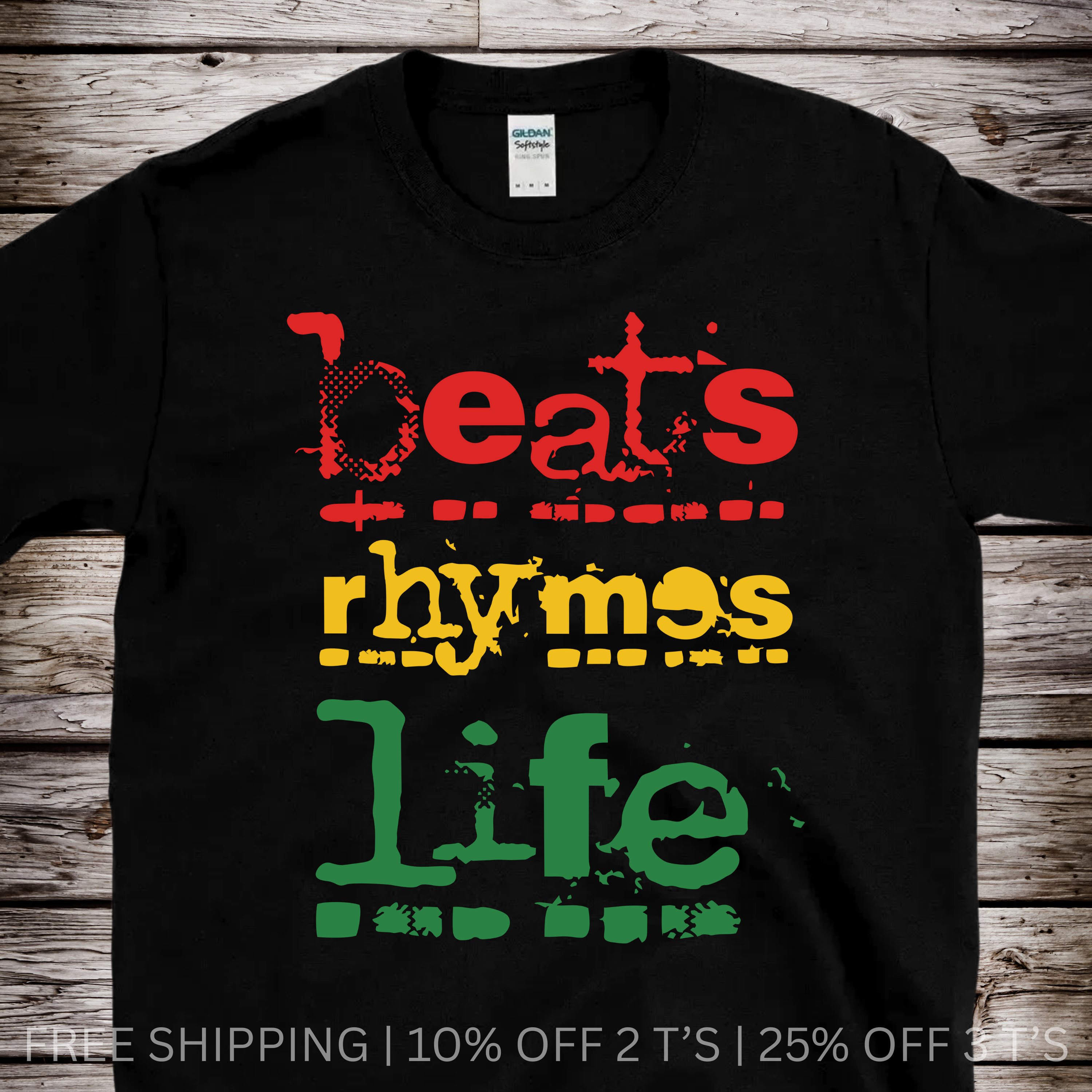 Black t-shirt with colorful text 'beats rhymes life' on a wooden surface