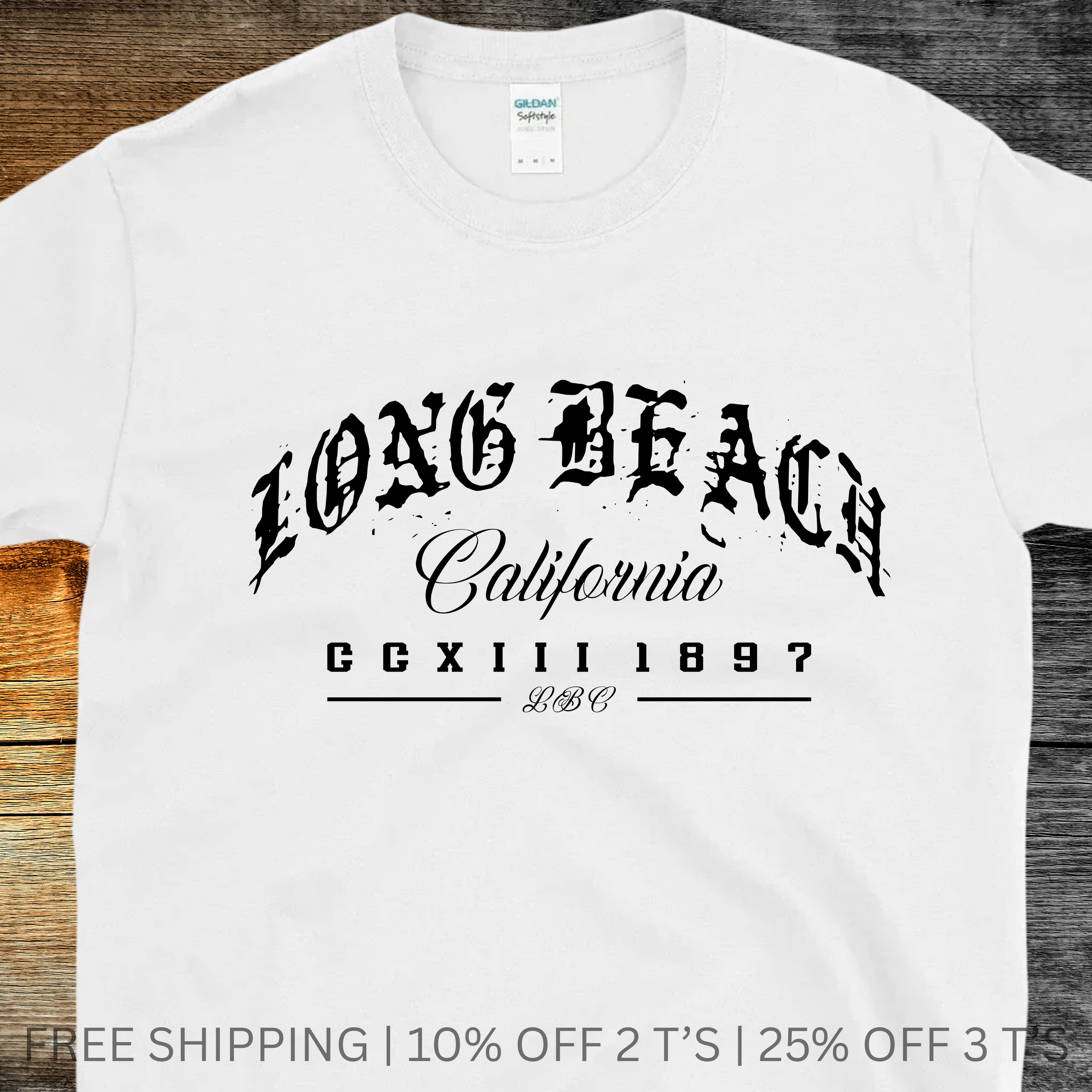 White t-shirt with 'Long Beach California' text on a wooden surface