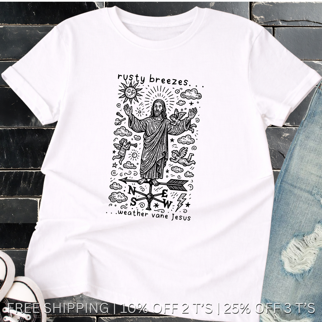 White t-shirt with black graphic design featuring a figure and text, placed on a dark surface.