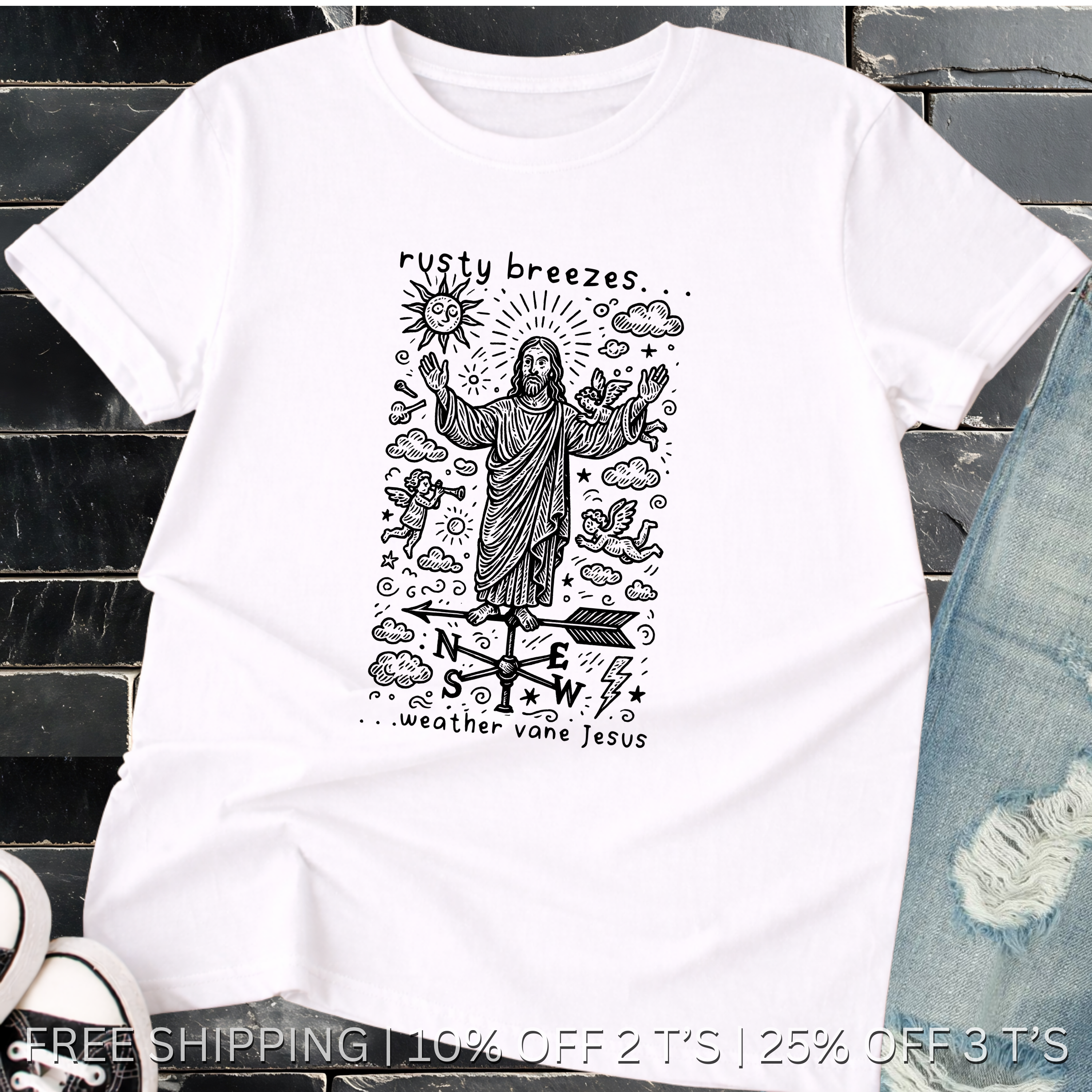 White t-shirt with black graphic design featuring a figure and text, placed on a dark surface.